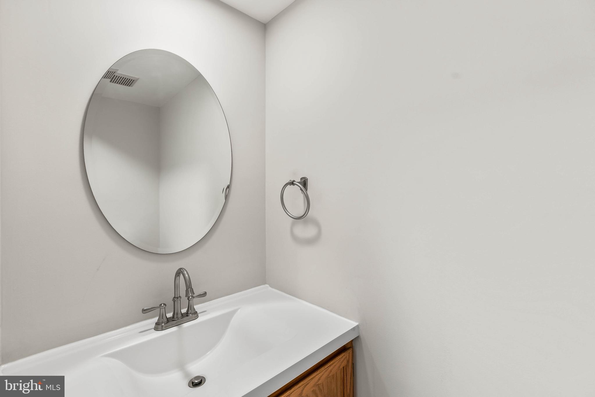 1868 Middlebridge Drive Silver Spring, MD 20906 - Photo 11 of 50 a bathroom with a sink and mirror