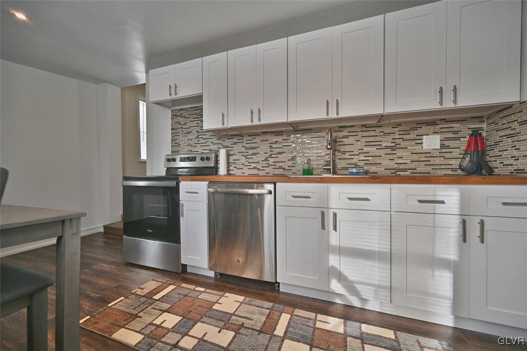 1412 Donalds Road Effort, PA 18330 - Photo 12 of 30 a kitchen with granite countertop a sink a stove and cabinets