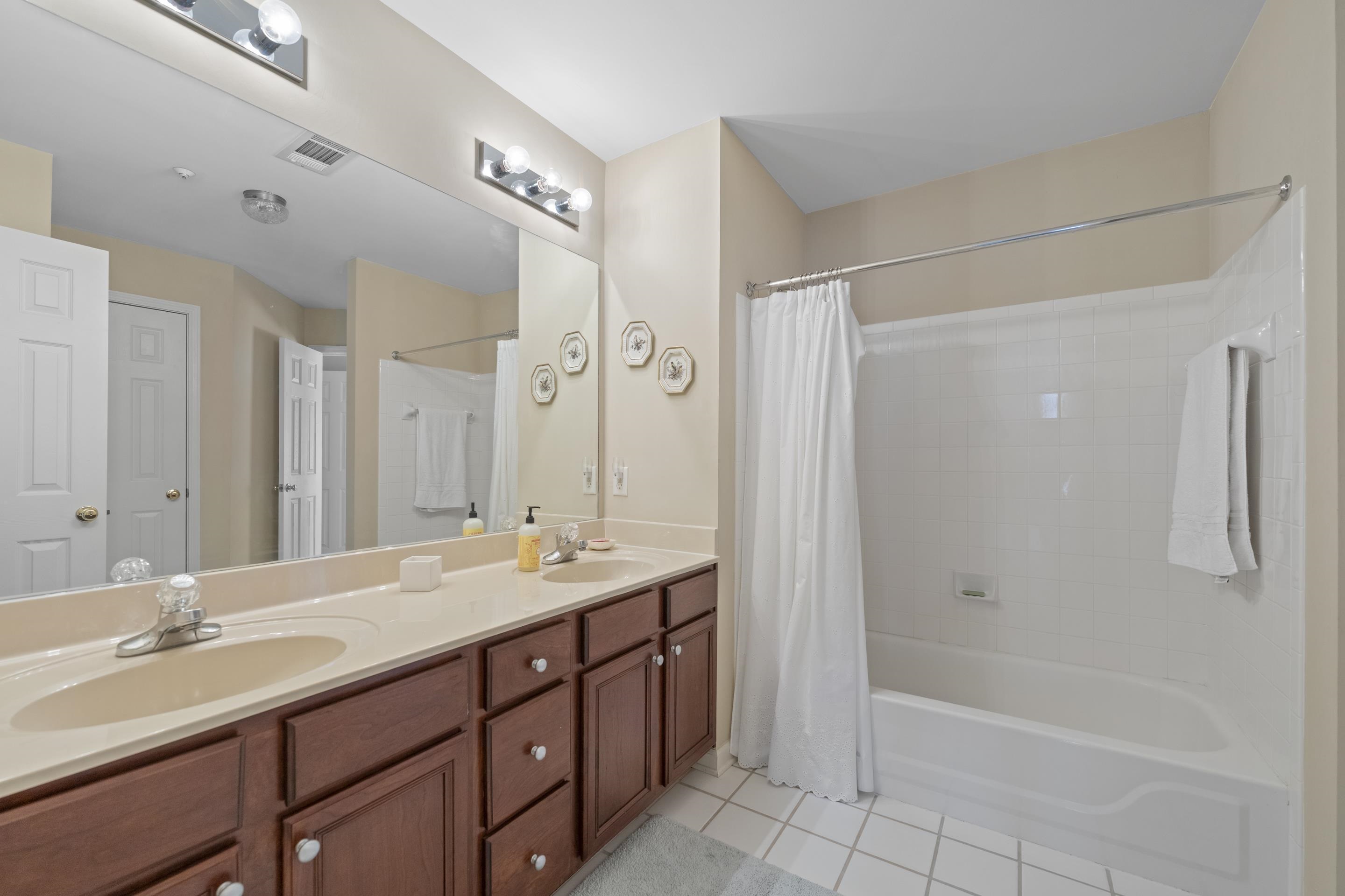 1701 Village Ridge Place Collierville, TN 38017 - Photo 24 of 38 a bathroom with a double vanity sink mirror double and bathtub