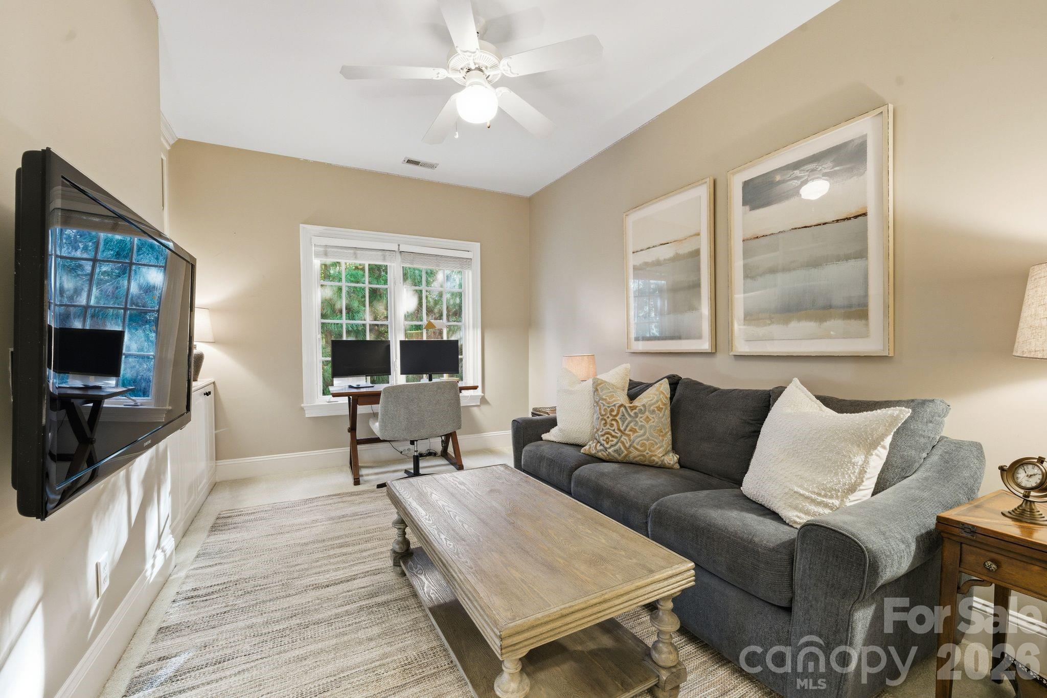 185 Quaker Road Mooresville, NC 28117 - Photo 28 of 43 a living room with furniture and a flat screen tv