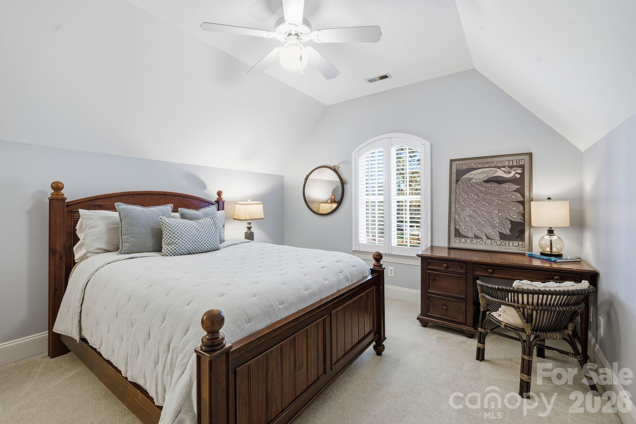 185 Quaker Road Mooresville, NC 28117 - Photo 30 of 43 a bedroom with a bed and a chandelier