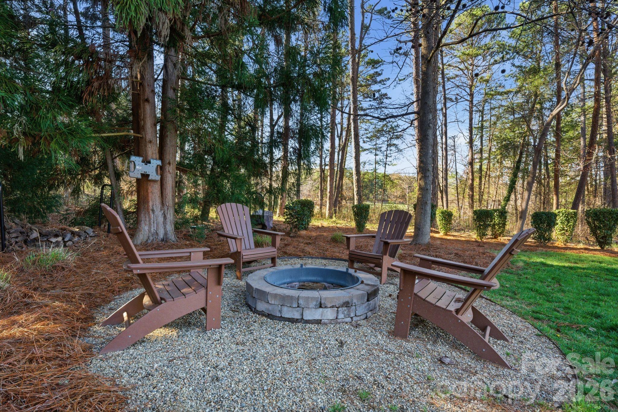 185 Quaker Road Mooresville, NC 28117 - Photo 38 of 43 a view of a backyard with sitting area and garden