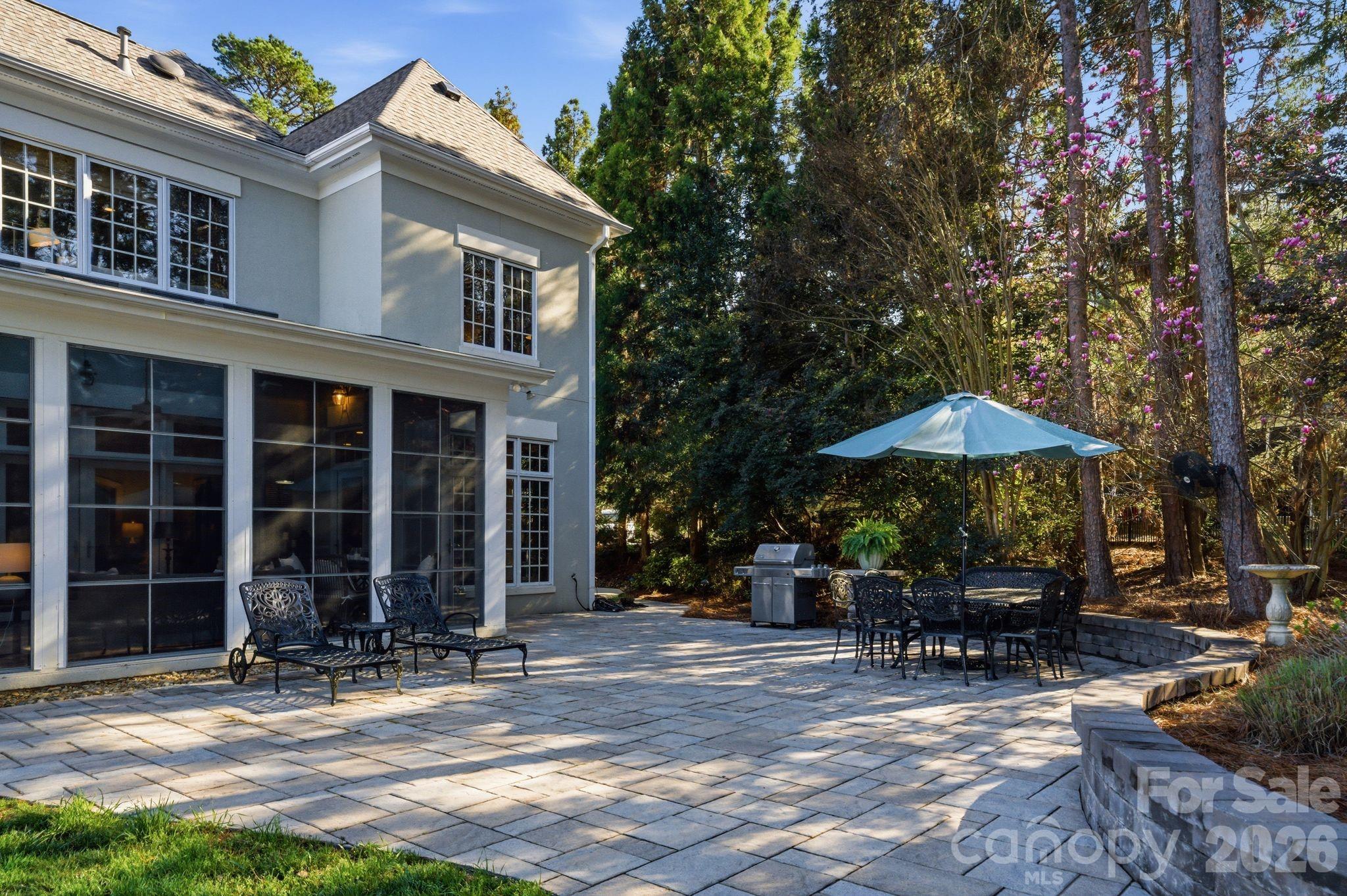 185 Quaker Road Mooresville, NC 28117 - Photo 40 of 43 a view of a patio with table and chairs under an umbrella