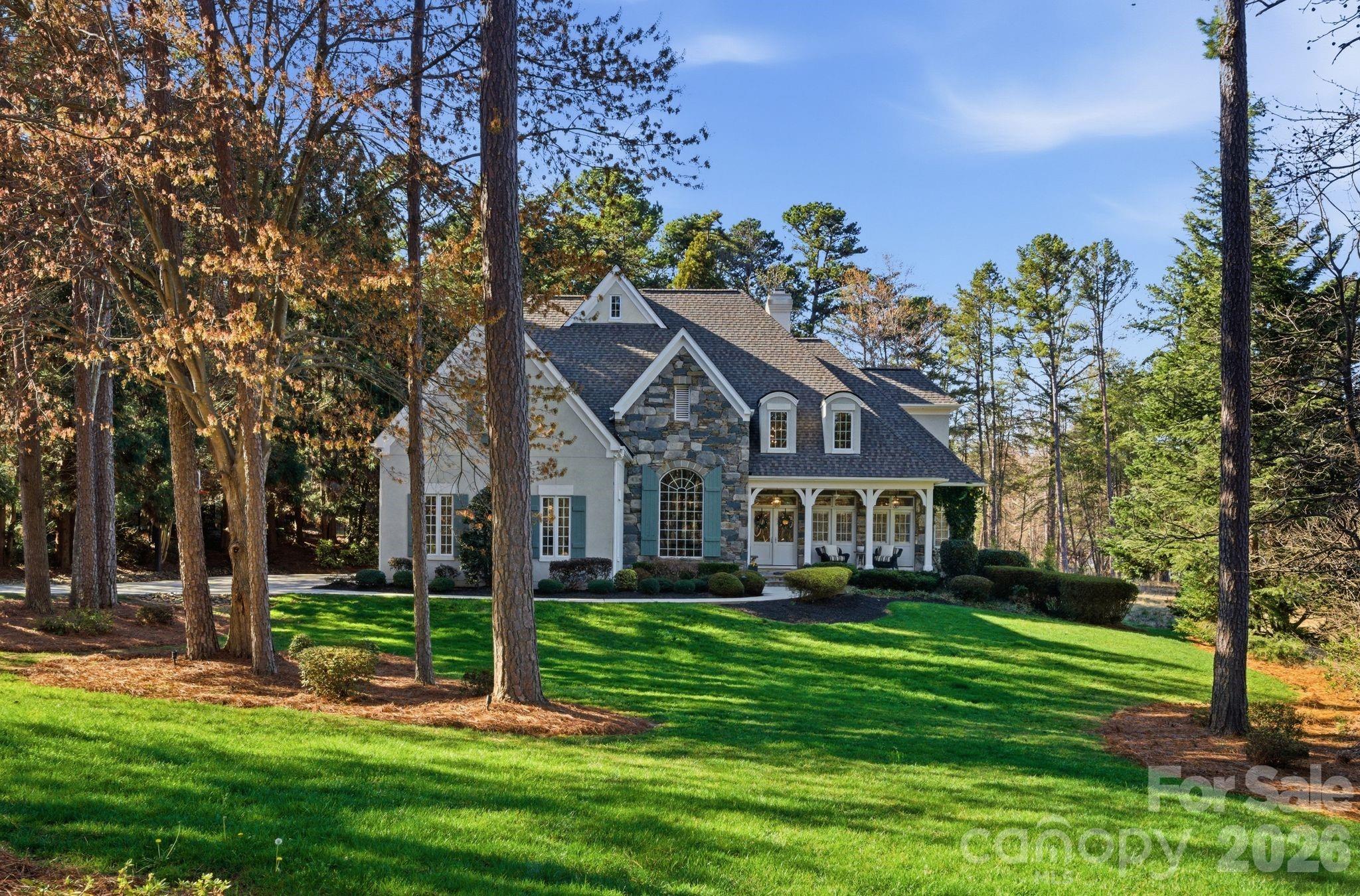 185 Quaker Road Mooresville, NC 28117 - Photo 42 of 43 a front view of a house with a yard table and trees