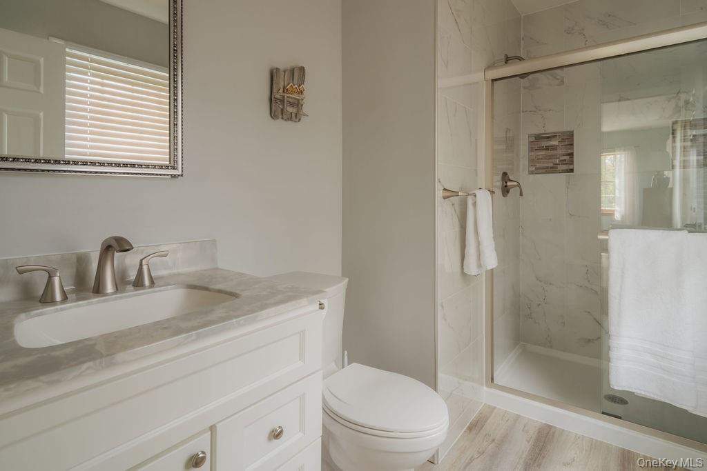 4 Echo Valley Road Red Hook, NY 12571 - Photo 17 of 33 a bathroom with a granite countertop sink toilet and shower