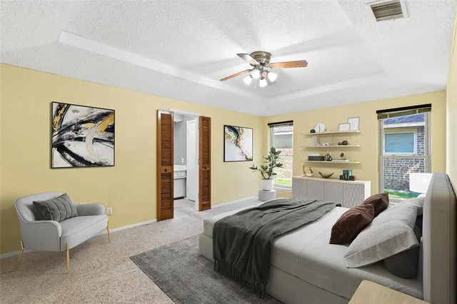 a bedroom with a large bed couch and a window