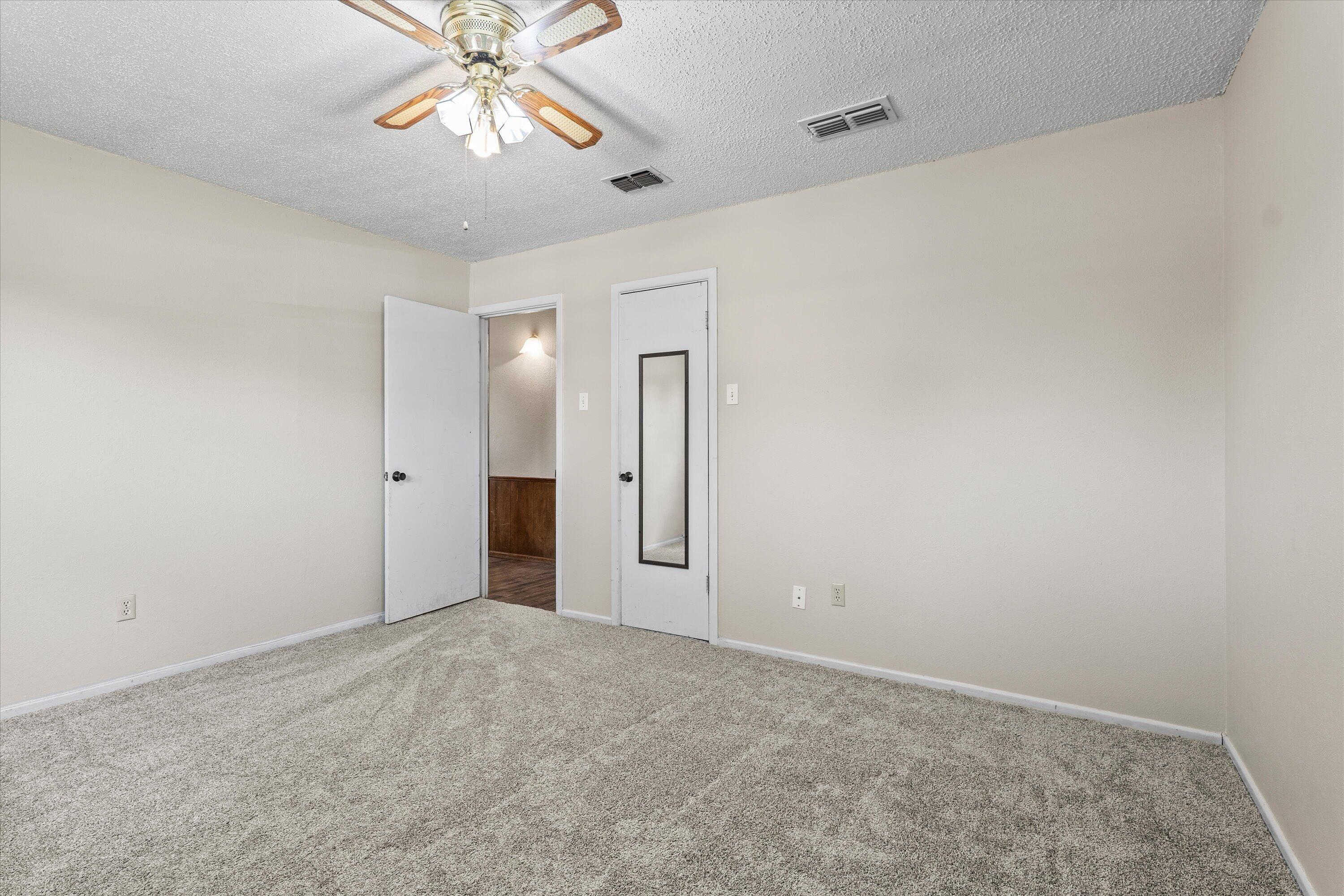 4520 54th Street Lubbock, TX 79414 - Photo 20 of 32 a view of an empty room and chandelier fan