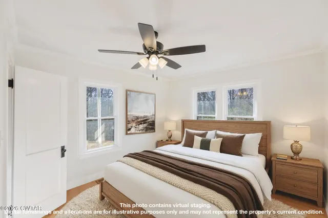 a view of a big room with wooden floor and windows
