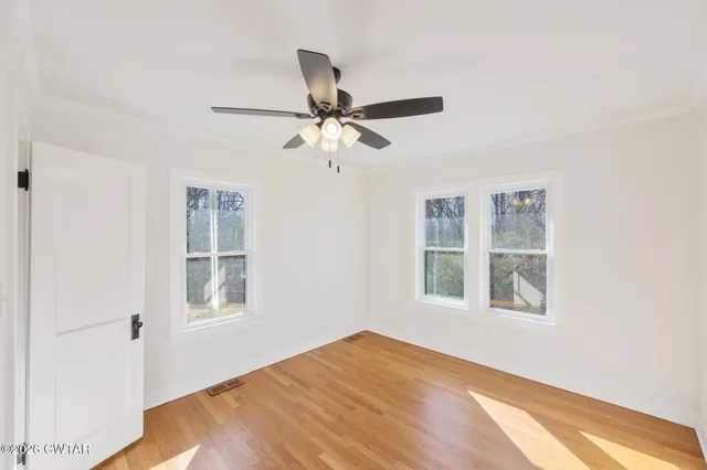 a view of closet with wooden floor