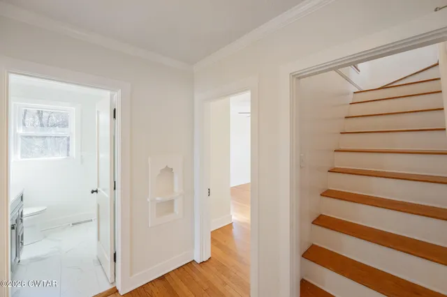 a view of empty room with wooden floor