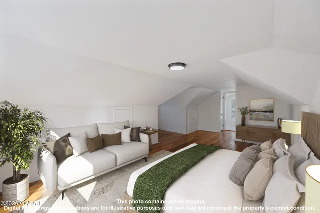 a view of a room with wooden floor and white walls