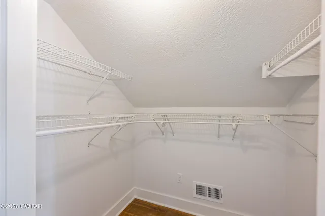 a spacious bathroom with a toilet sink and mirror