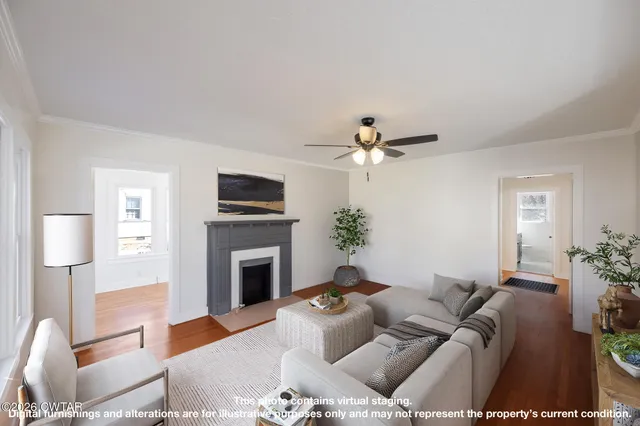 a view of empty room with wooden floor and fireplace