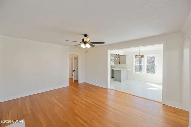 a kitchen with stainless steel appliances a sink a refrigerator and window