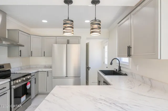 a kitchen with stainless steel appliances a stove and a refrigerator