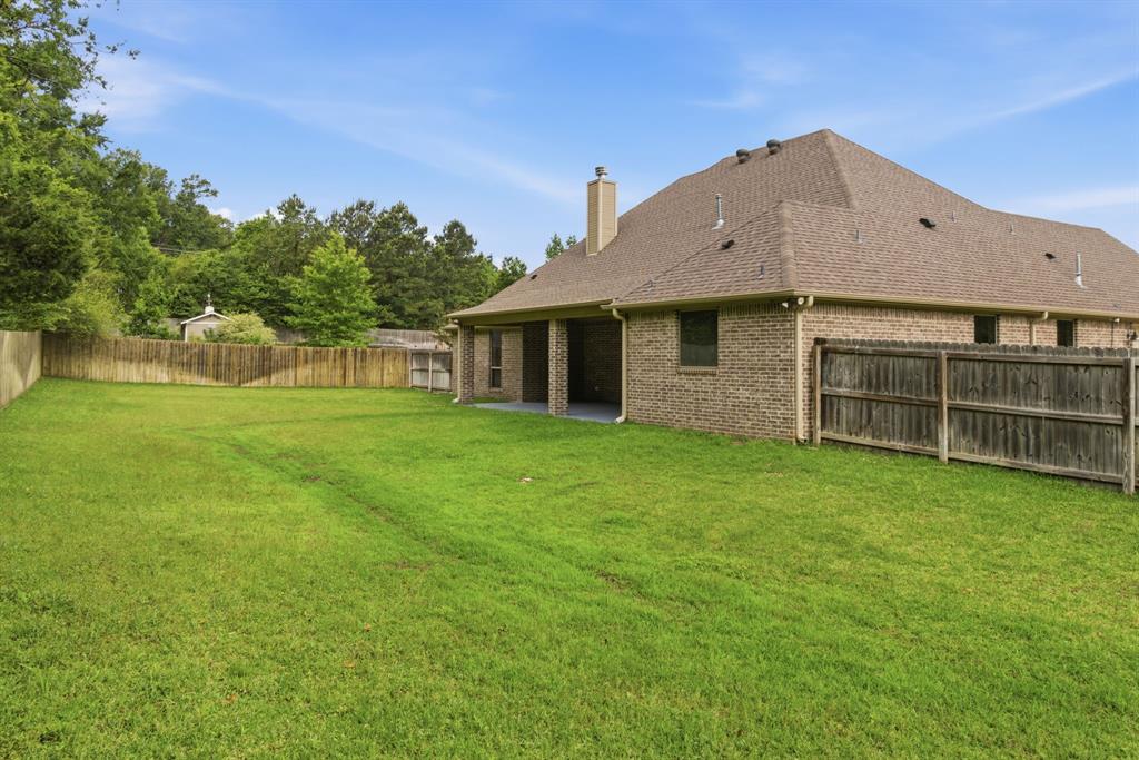 7765 Hickory Spring Lane Tyler, TX 75703 - Photo 38 of 38 Expansive grassy yard enclosed by a wood privacy fence