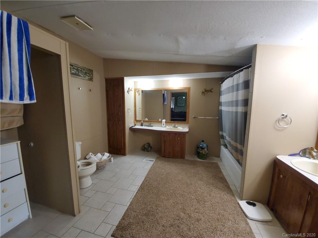 483 Freeman Road Forest City, NC 28043 - Photo 14 of 21 a bathroom with a sink a mirror and a toilet