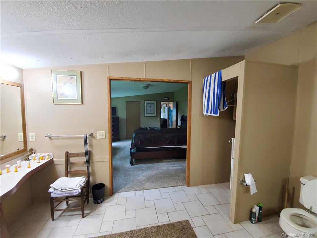483 Freeman Road Forest City, NC 28043 - Photo 15 of 21 a bathroom with a sink a toilet and a mirror
