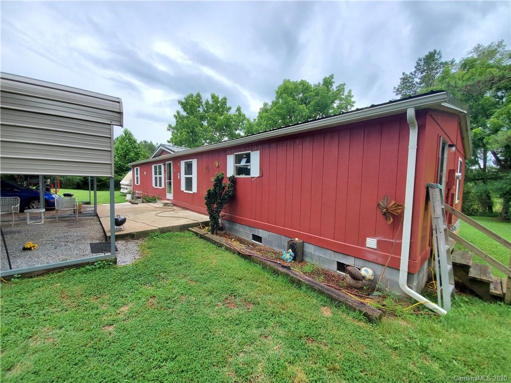 483 Freeman Road Forest City, NC 28043 - Photo 17 of 21 a view of a backyard with a sitting area and a small barn