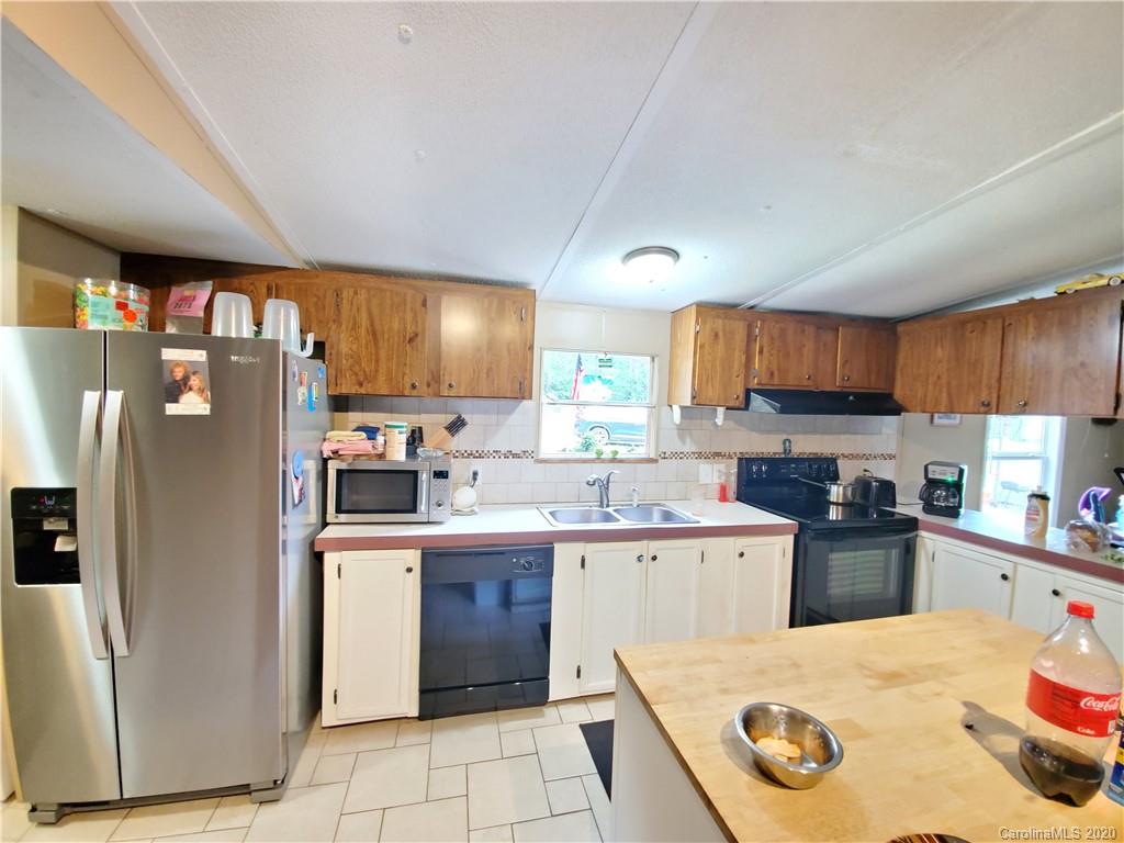 483 Freeman Road Forest City, NC 28043 - Photo 5 of 21 a kitchen with granite countertop a sink a counter top space stainless steel appliances and cabinets