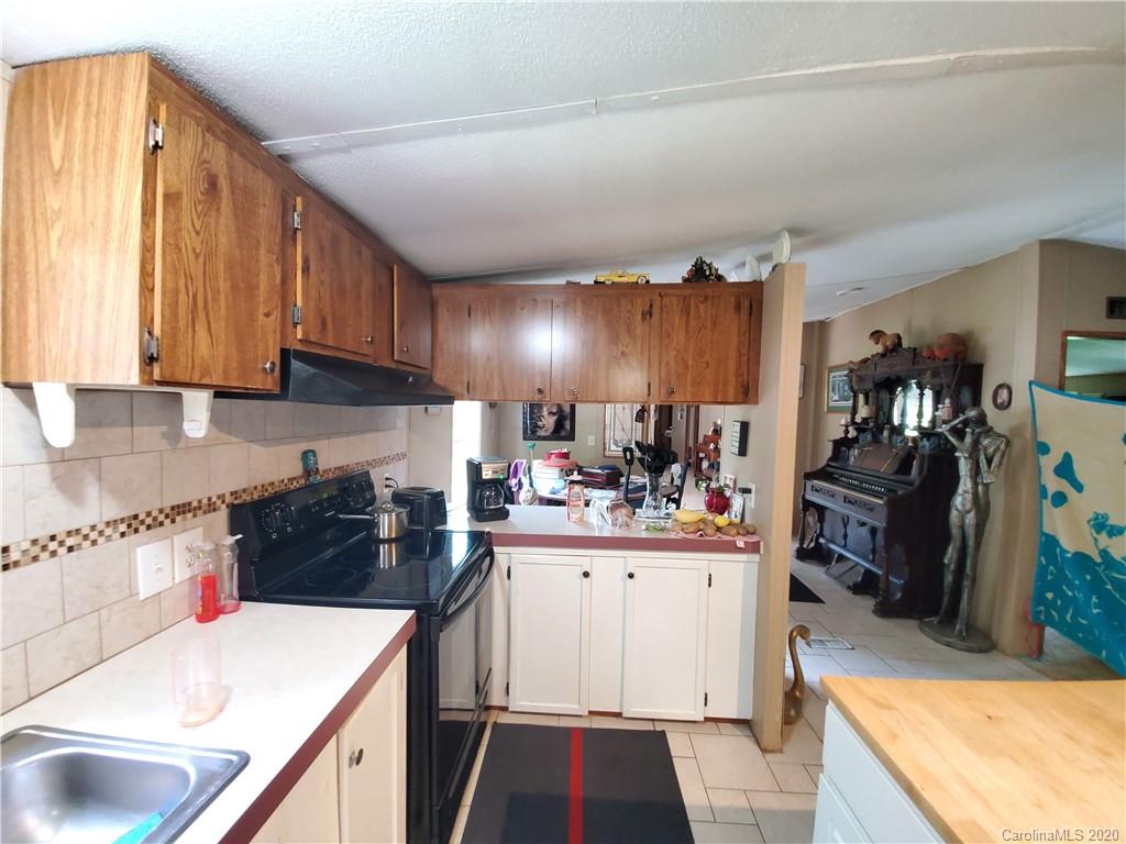483 Freeman Road Forest City, NC 28043 - Photo 6 of 21 a kitchen with a stove a refrigerator and a sink