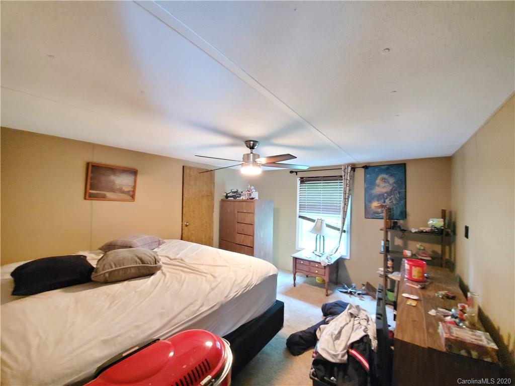483 Freeman Road Forest City, NC 28043 - Photo 8 of 21 a bedroom with double bed and a chandelier