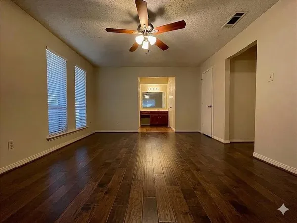a view of a room with wooden floor and chandelier