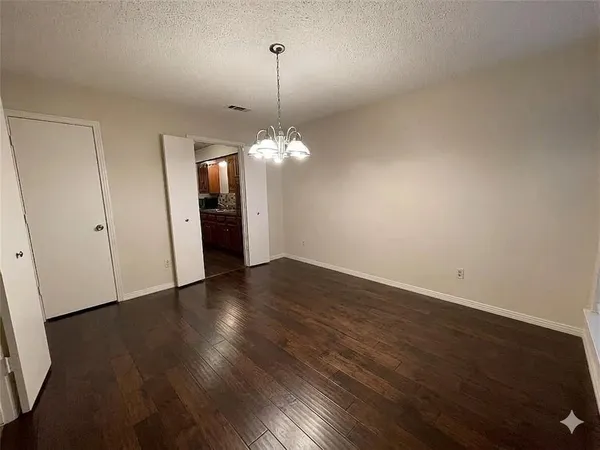a view of a room with wooden floor and window
