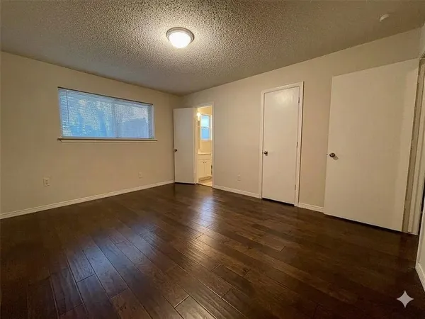 a view of a room with wooden floor and fan