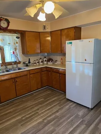 a kitchen with stainless steel appliances granite countertop a refrigerator sink and cabinets