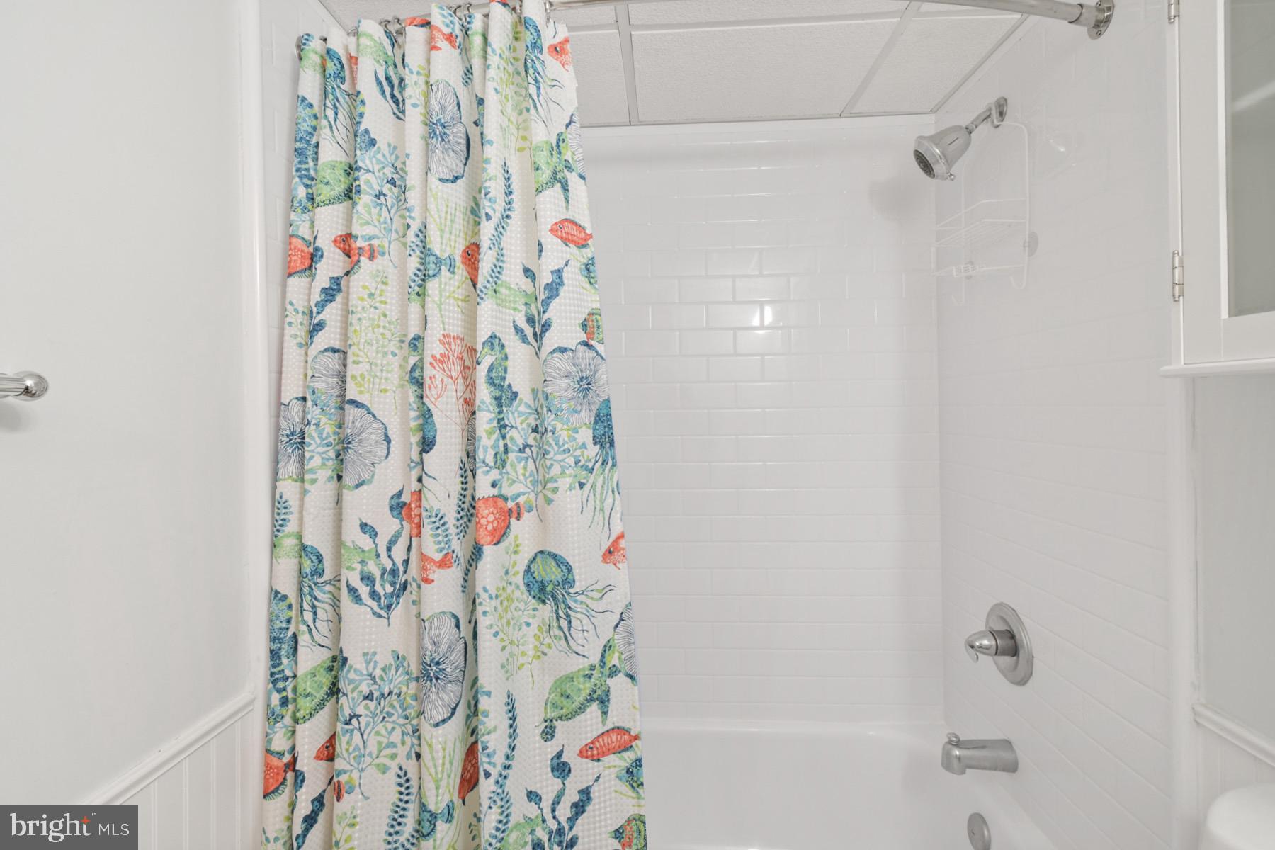 722 Mooring Road, Unit A104 Ocean City, MD 21842 - Photo 25 of 33 a bathroom with a bathtub and shower curtain