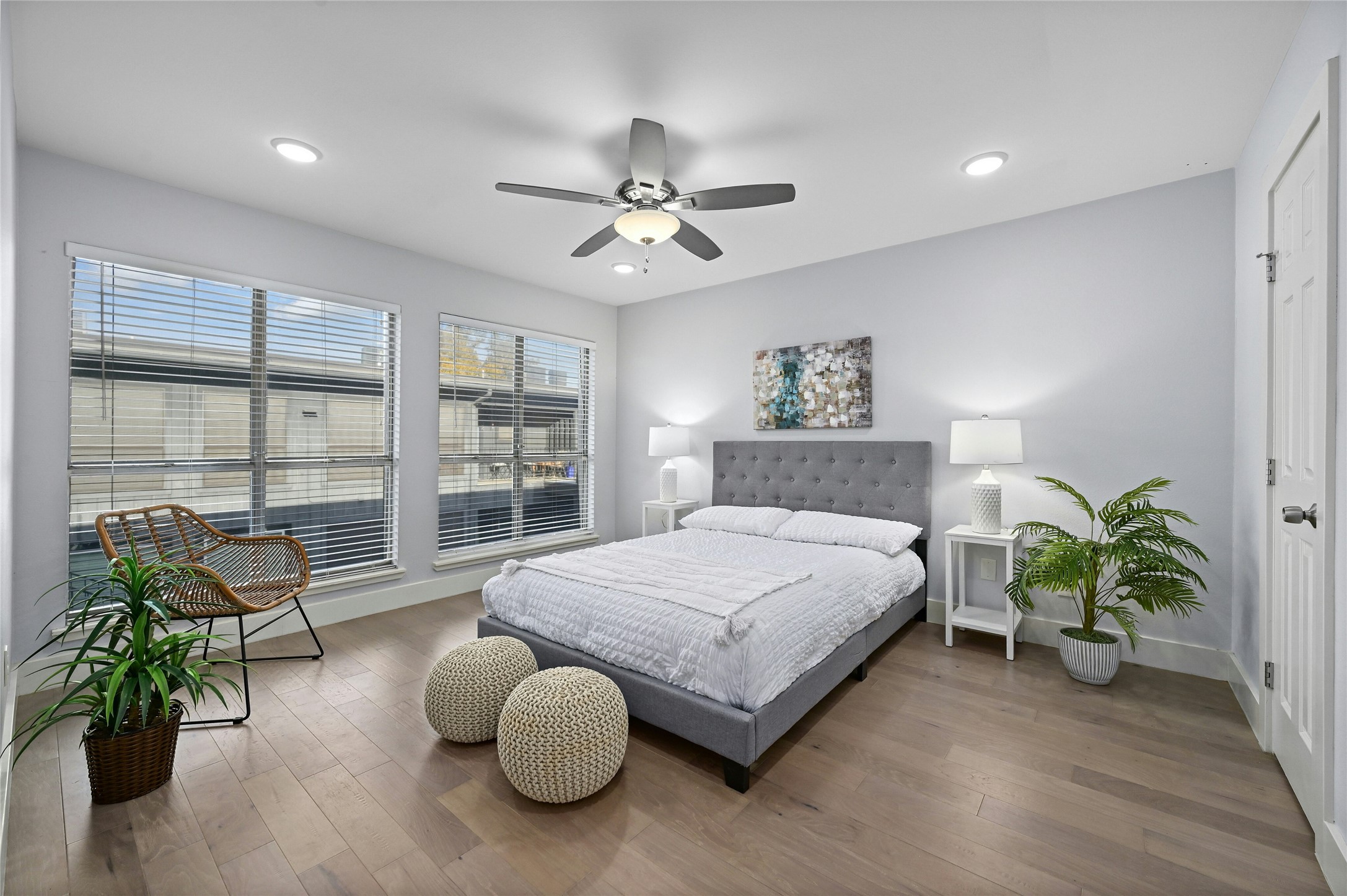909 Reinli Street, Unit 228 Austin, TX 78751 - Photo 12 of 27 a spacious bedroom with a bed table flowerpot and window