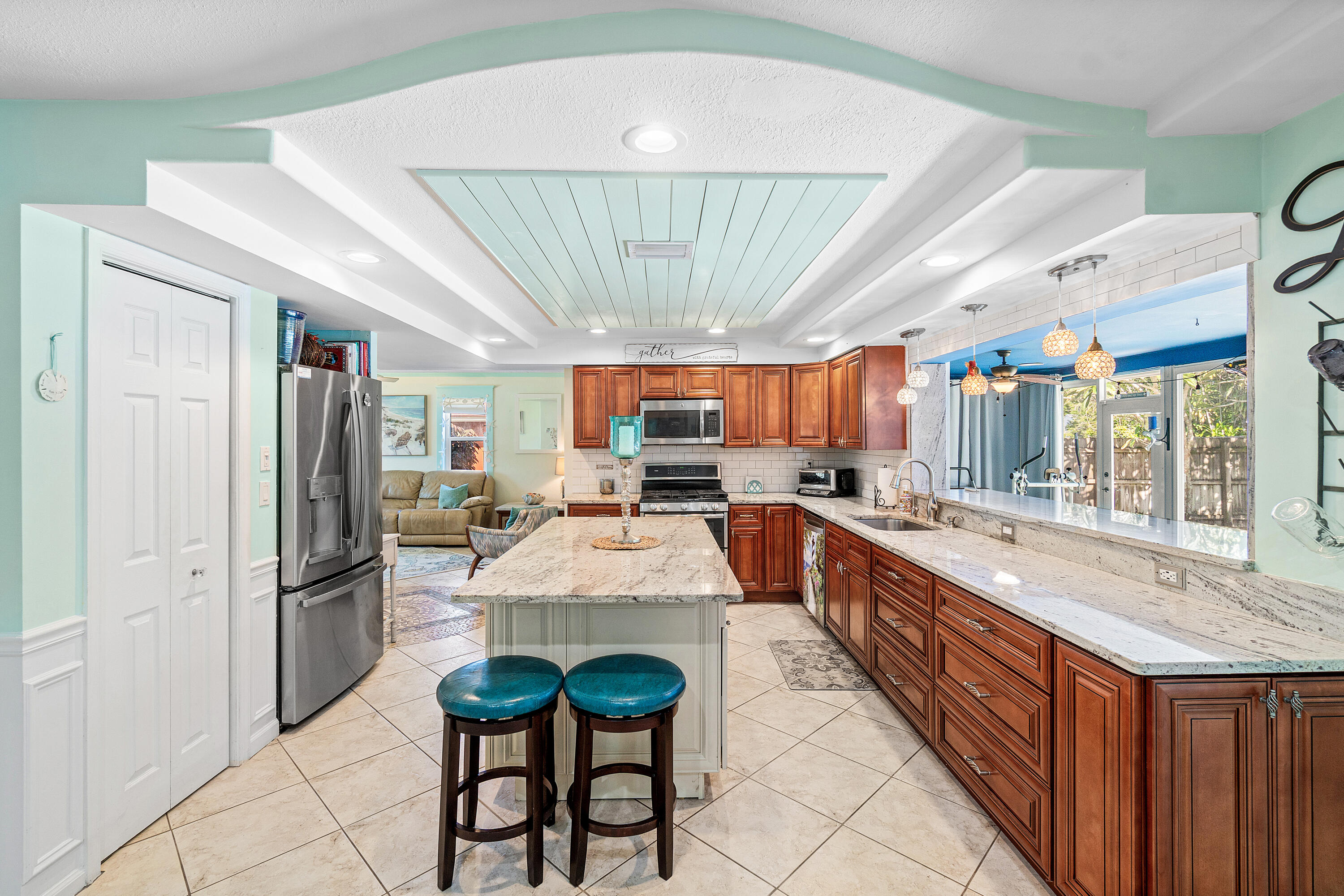 1108 Petrel Road Wellington, FL 33414 - Photo 14 of 46 a large white kitchen with a large window and stainless steel appliances