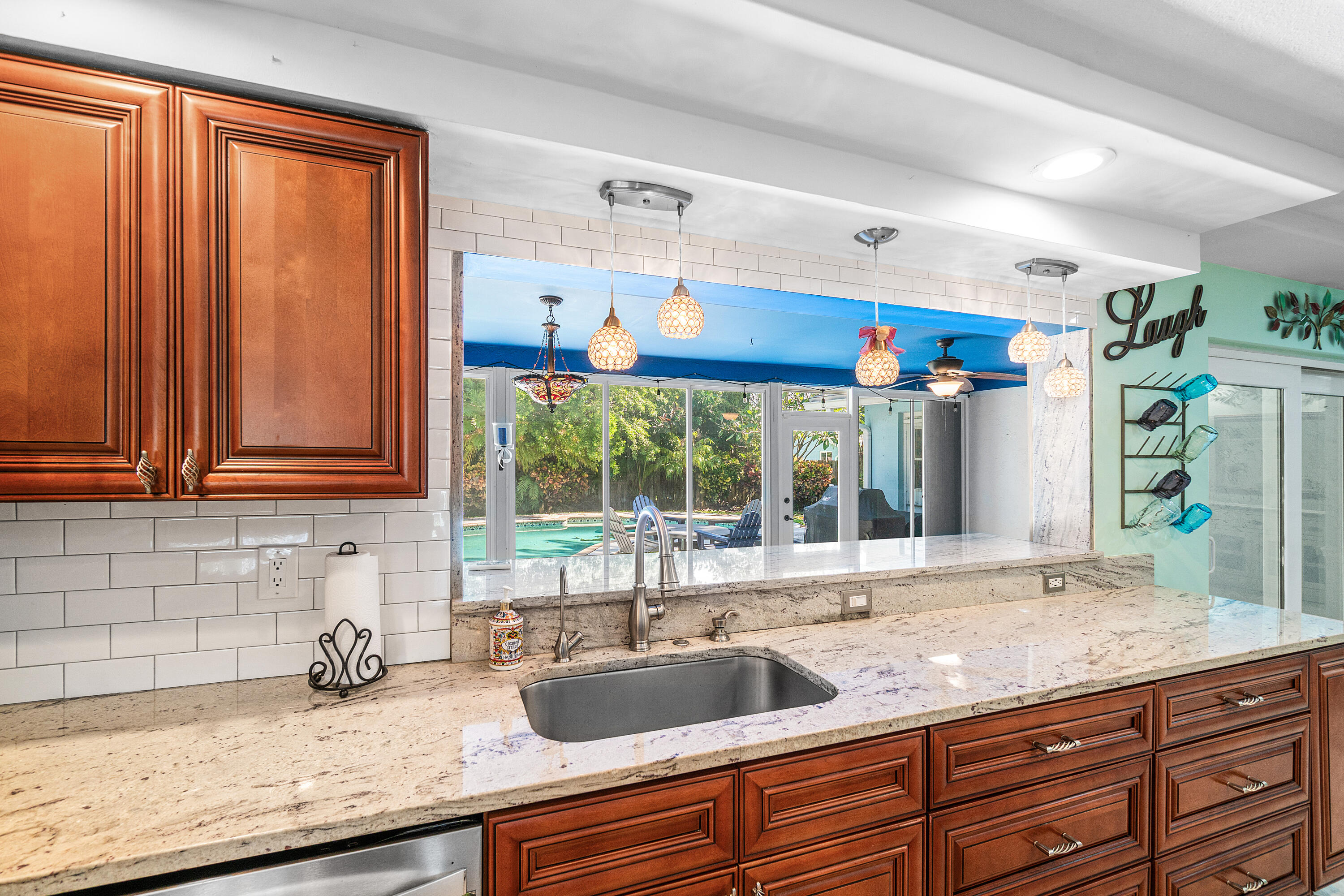 1108 Petrel Road Wellington, FL 33414 - Photo 15 of 46 a kitchen with granite countertop a sink and a window