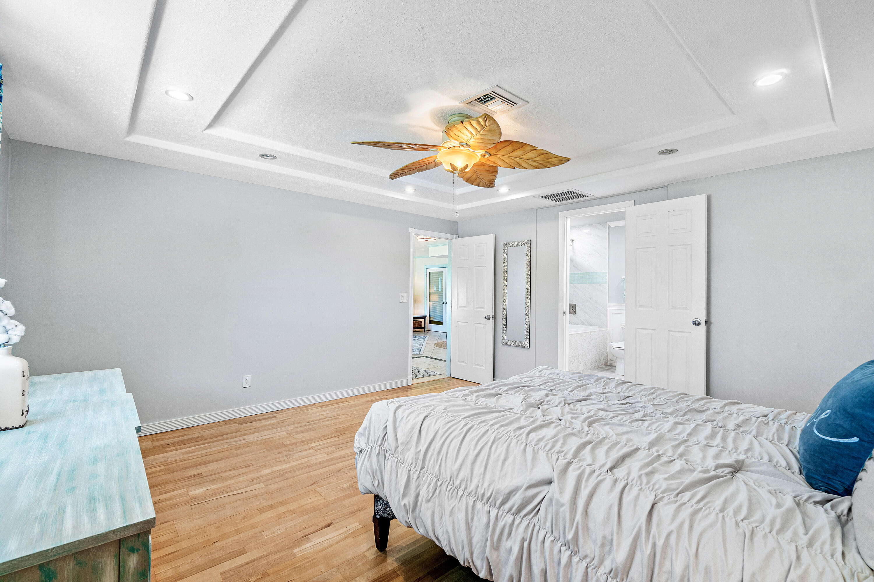 1108 Petrel Road Wellington, FL 33414 - Photo 23 of 46 a bedroom with a bed and a chandelier