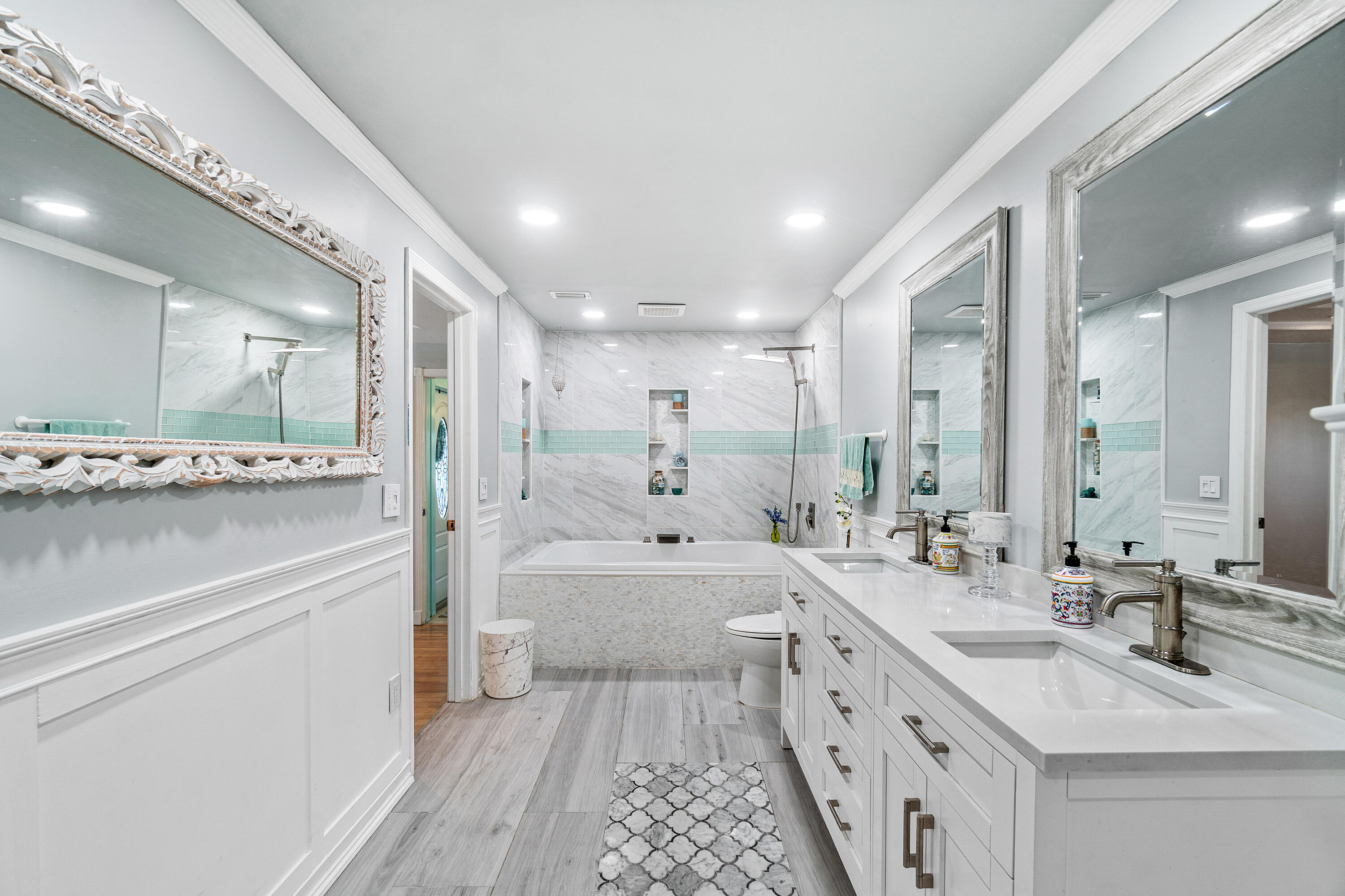 1108 Petrel Road Wellington, FL 33414 - Photo 26 of 46 a large bathroom with a double vanity sink a mirror and a bathtub