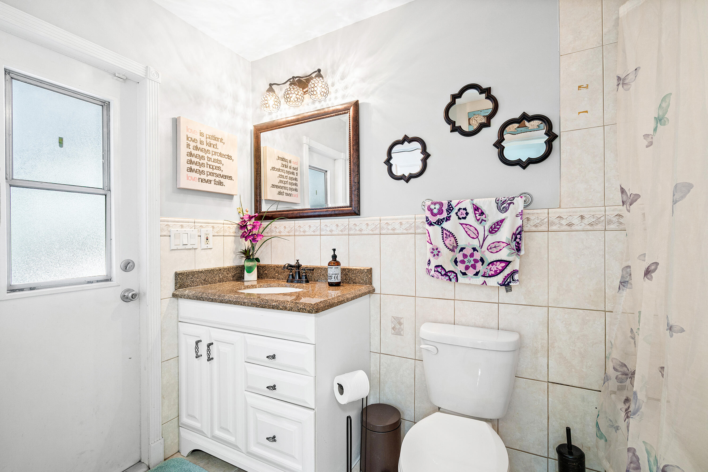 1108 Petrel Road Wellington, FL 33414 - Photo 32 of 46 a bathroom with a toilet sink and mirror