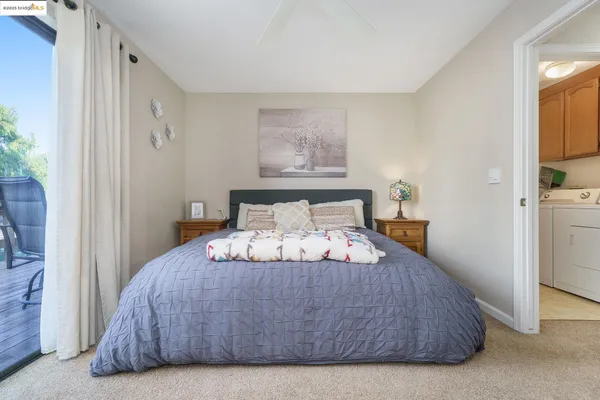 a bedroom with a bed and painting on the wall