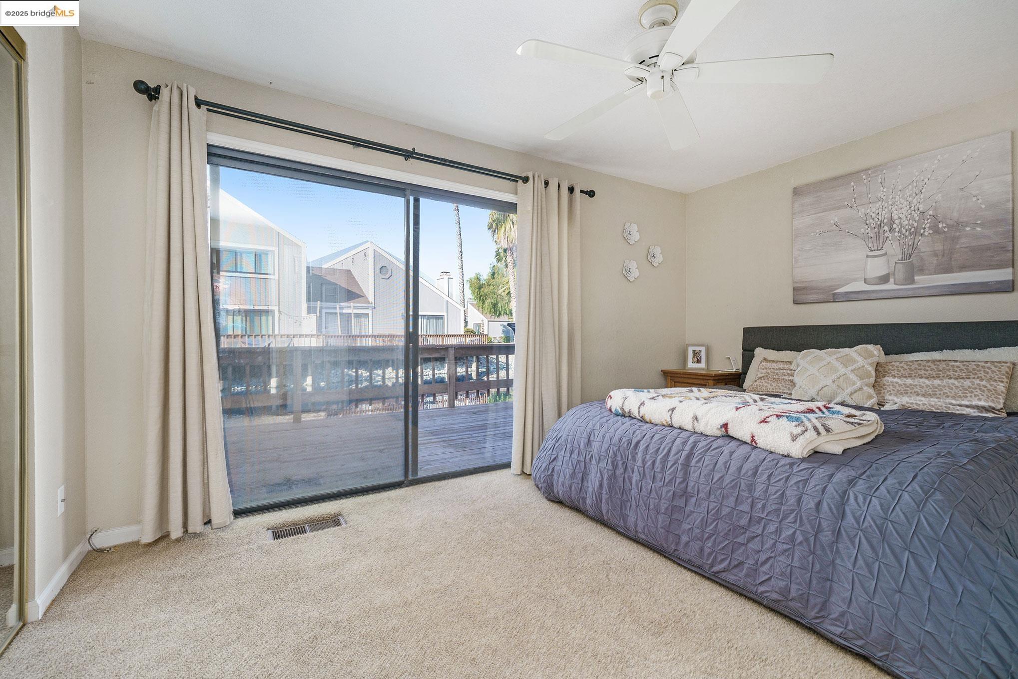 2013 Sand Point Road Discovery Bay, CA 94505 - Photo 16 of 28 a bedroom with a bed and glass door