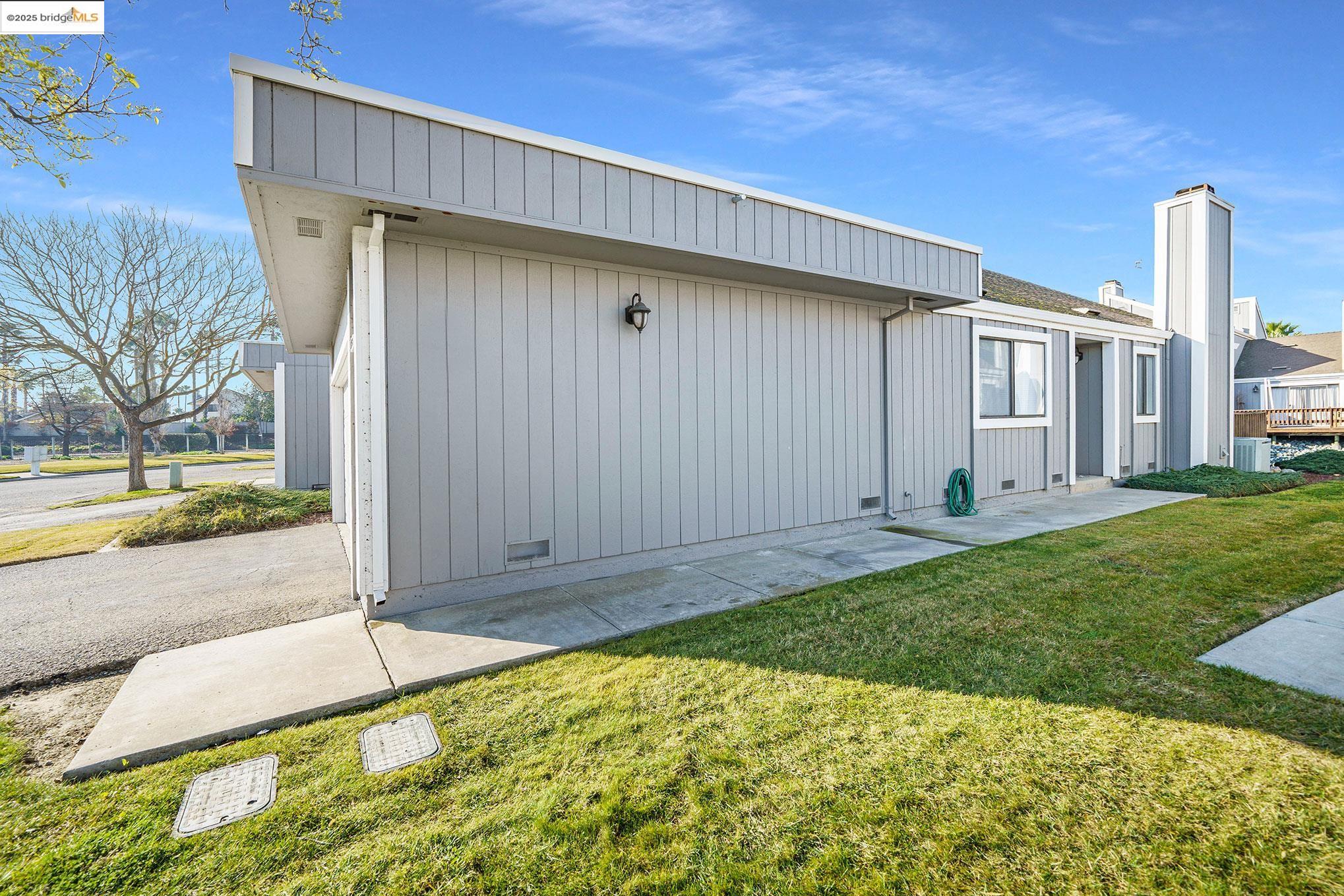 2013 Sand Point Road Discovery Bay, CA 94505 - Photo 3 of 28 a front view of a house with garden