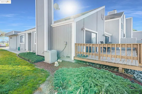 a view of a house with backyard and sitting area