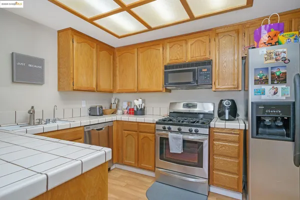 a kitchen with stainless steel appliances granite countertop a stove and a sink