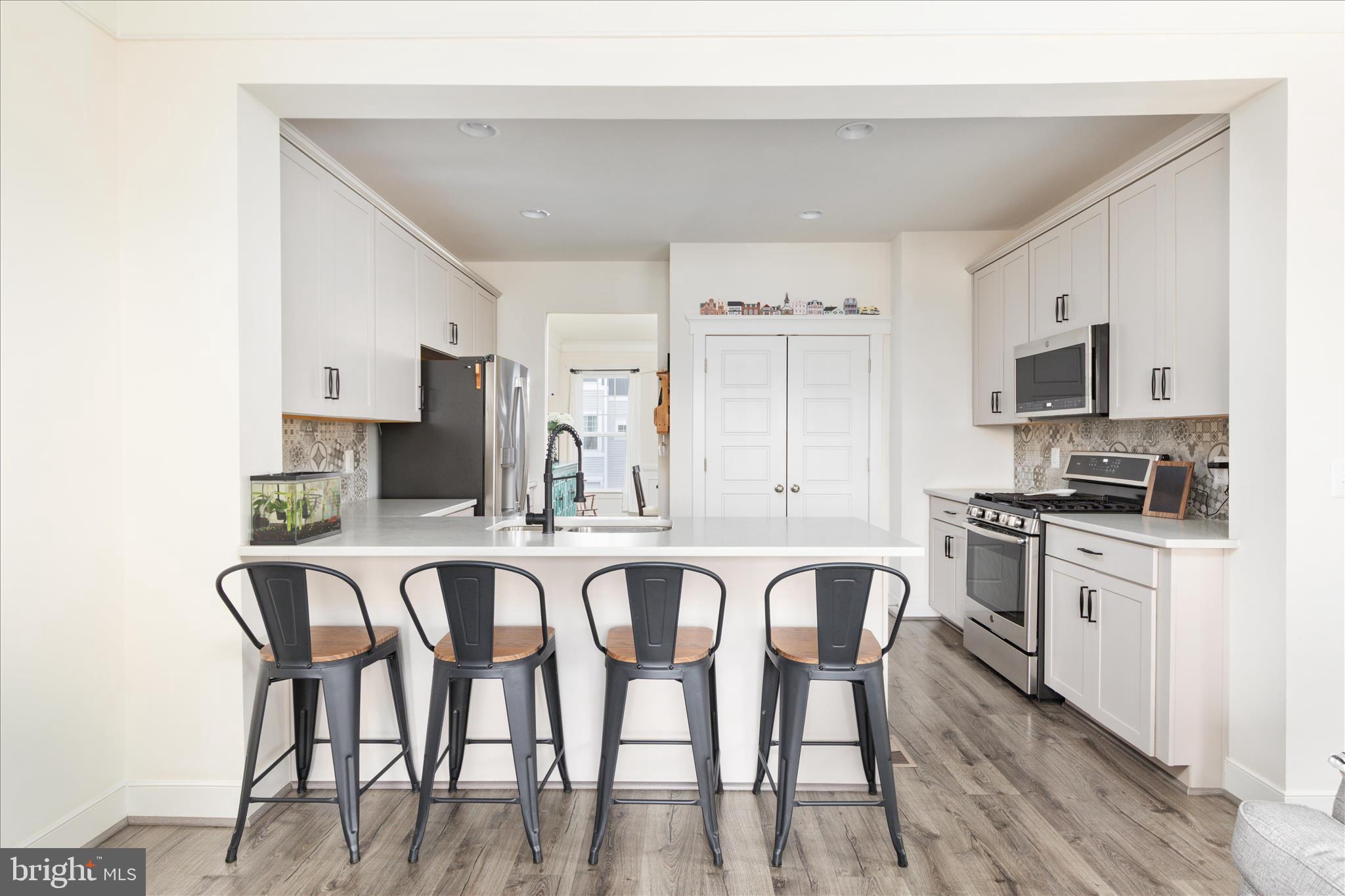110 Halo Court Stephenson, VA 22656 - Photo 5 of 64 a kitchen with stainless steel appliances granite countertop a table chairs microwave and sink