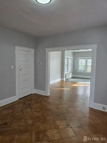 a view of wooden floor and entryway