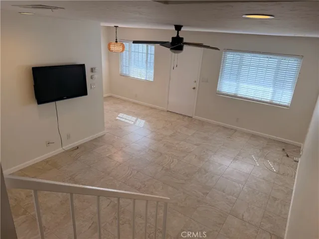 a view of a livingroom with an empty space and a window