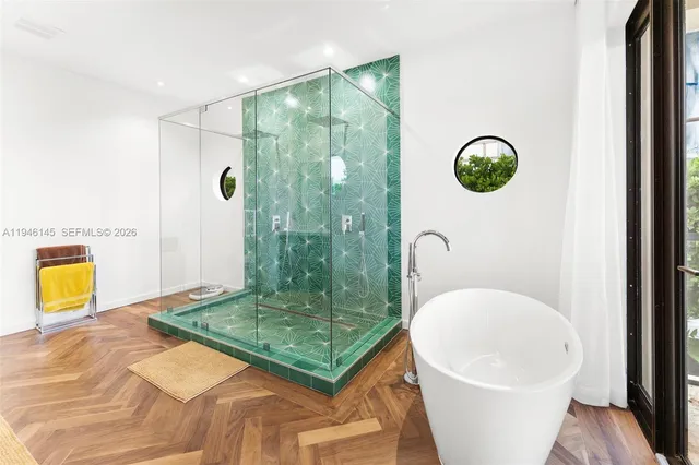 a bathroom with a sink a bathtub and shower