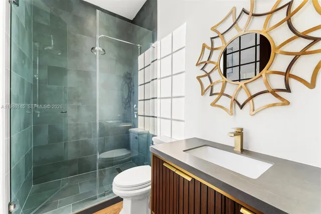 a bathroom with a sink toilet and shower