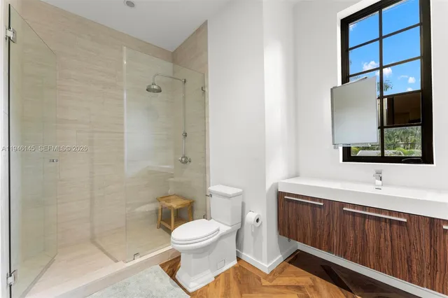 a bathroom with a sink a toilet and shower