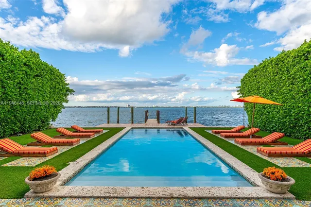 swimming pool view with two chairs