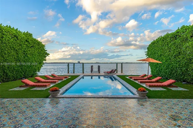 a backyard of a house with barbeque oven table and chairs